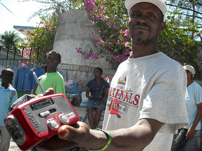 Man receives handcrack radio (Winnie Romeril)