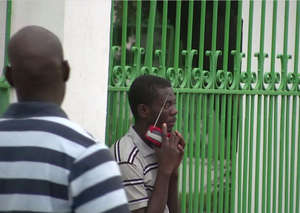 Listening to a portable radio, Port-au-Prince