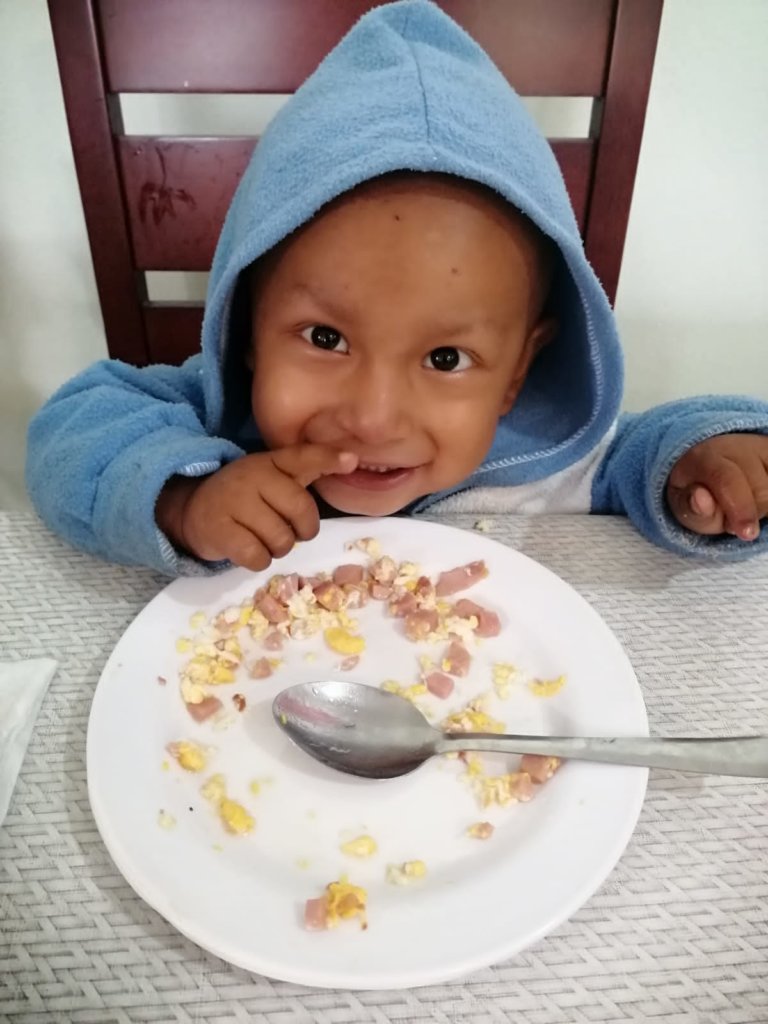 Two year old Alex smiling after his yummy lunch