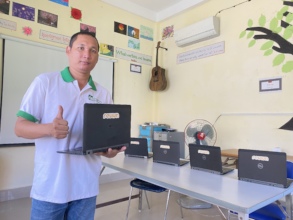 ICT Teacher with our new donation from REVIVN