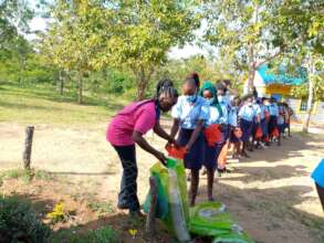 A student receives her food parcel