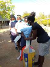 Students line up for bags of rice