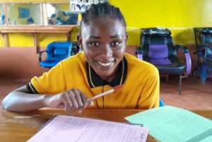 A student taking her national exam at Seed of Hope