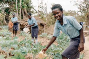 Student waters the crops at Kitui Seed of Hope