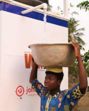 Child collects water from the Maji Kiosk