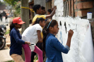 Youth paint informative murals about COVID-19