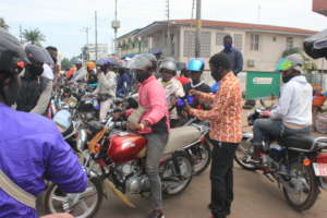 Distributing cloth masks to bike riders