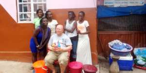 Group of beneficiaries with buckets and soap
