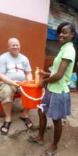 Beneficiaries with bucket and soap