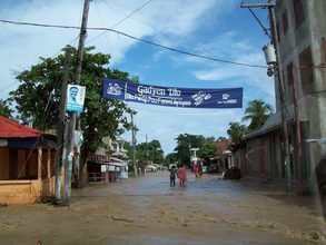 Leogane - Gadyen Dlo banner over flooded street
