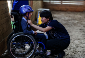 A volunteer and rider
