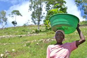 Woman with her plantings to reduce soil erosion