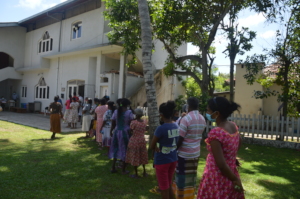 A long line of people waiting to receive goods