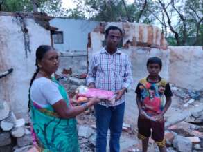 Nandri helping a family whose home was destroyed