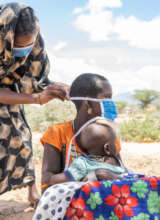 CHAT CORP assisting a mother to put on her mask