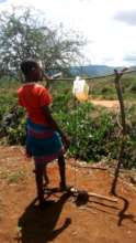 A youth using a handwashing station set up by CORP