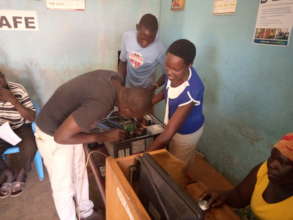 A CHILD MOTHER LEARNING HOW TO REPAIR COMPUTER