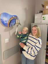 Teddy and mum ringing the bell at end of treatment