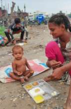 Feeding nutritious meal to a child in slum