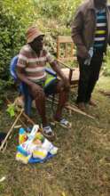 Donating food stuffs to old man in paponditi