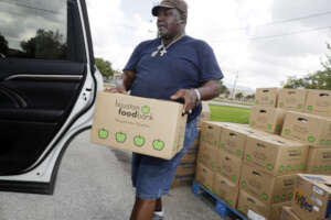 Families receive food boxes at distribution