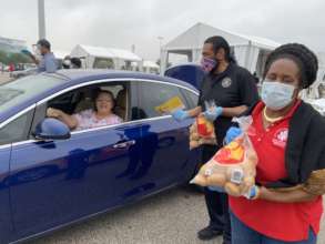 Volunteers work drive-thru food distribution