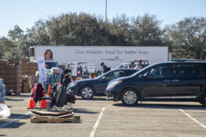 Cars wait in line at NRG Stadium distribution.