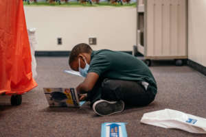 A student at Mason Academy reads their new books