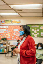A teacher prepares students to select their books