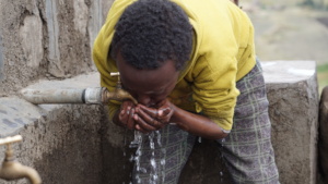 A child drinking from the newly built water point