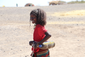 Afar Girl Keeps the water cool at the desert