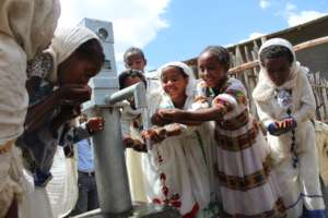 Rural girls enjoying water from Drop of water well