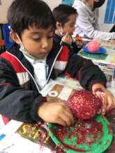 Emiliano creating a Christmas present