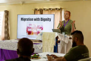 Erin Thomas speaking alongside the Rabi Delegation