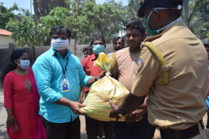 Don Bosco officials handing over the food kits
