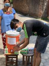 Boy using handwash in the street