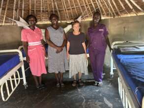Carol with two clinic nurses inside maternity hut