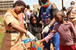 Scouts distributing soap to community members