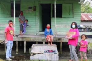 A family receiving YUM's basic food package