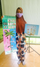 A volunteer with her height chart and flip card