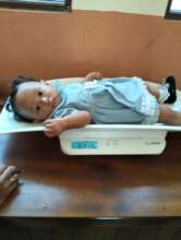 Weighing babies to check their nutritional status