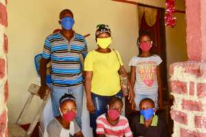 A family on Lagonav with masks you made possible.