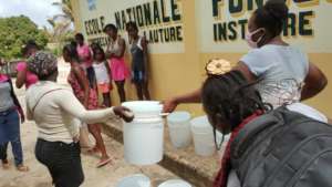 Distributing hygiene kits at a Jacmel girls' club.