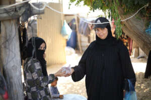 Amira delivering meat to a family in need.