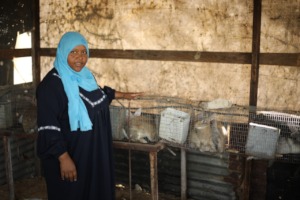 Shireen in front of her rabbit hutch.
