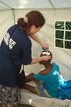 Dr. Orna Hananel treats a patient's head wound.