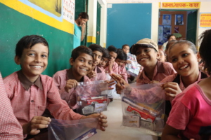 Smiling faces with hygiene kits