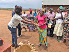 Betty distributing new farm tools to the Group