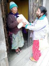 Elderly woman receiving pantry supplies