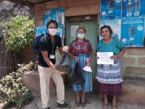 Beneficiary family receiving their pantry supplies